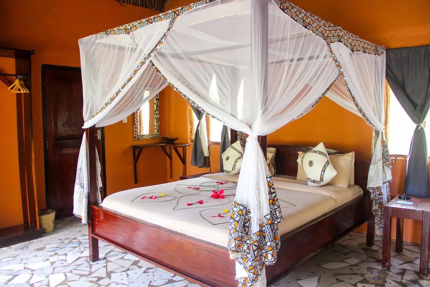 Pool bungalow bedroom with a canopy bed