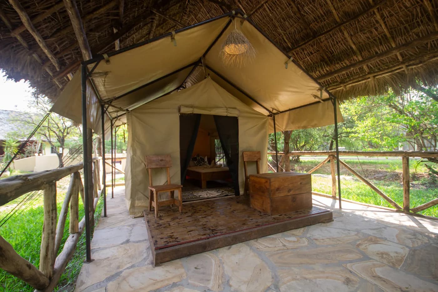 Safari tent under a thatched shelter