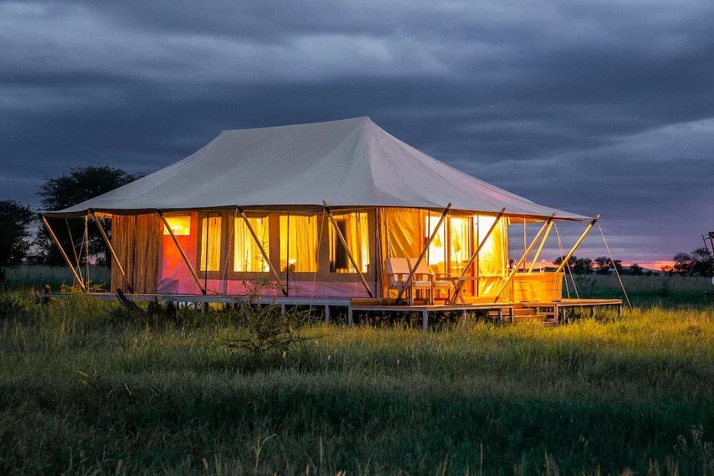 Guest tent lit up at dusk