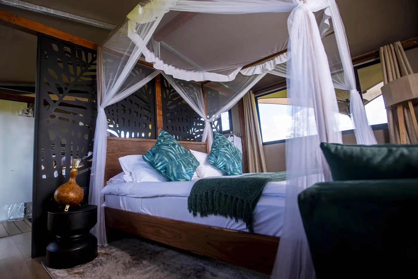 Canopied bed with teal cushions