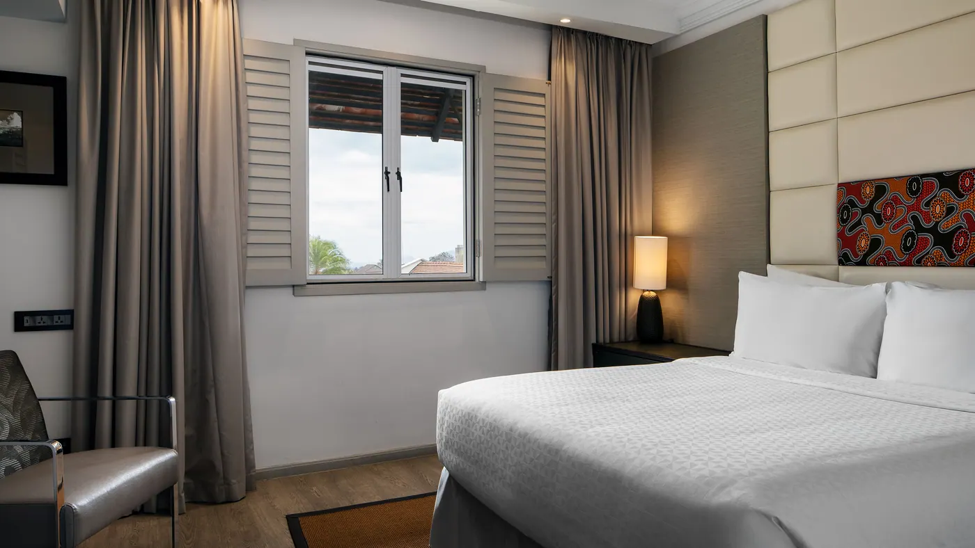 Bed beside the shuttered window