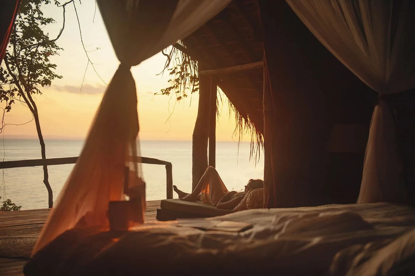 Bed looking out to the lake at sunset