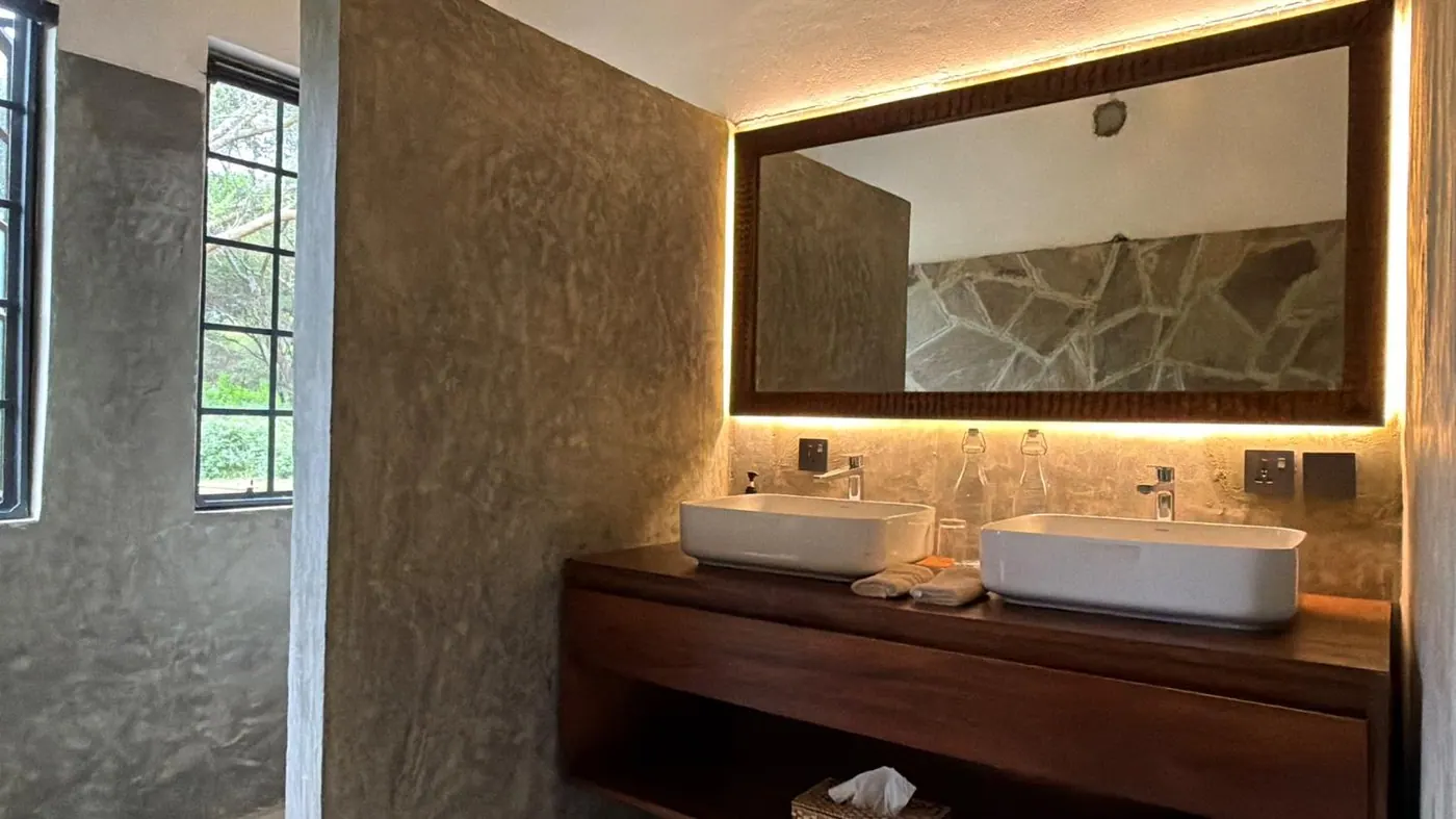 Backlit mirror above the basins