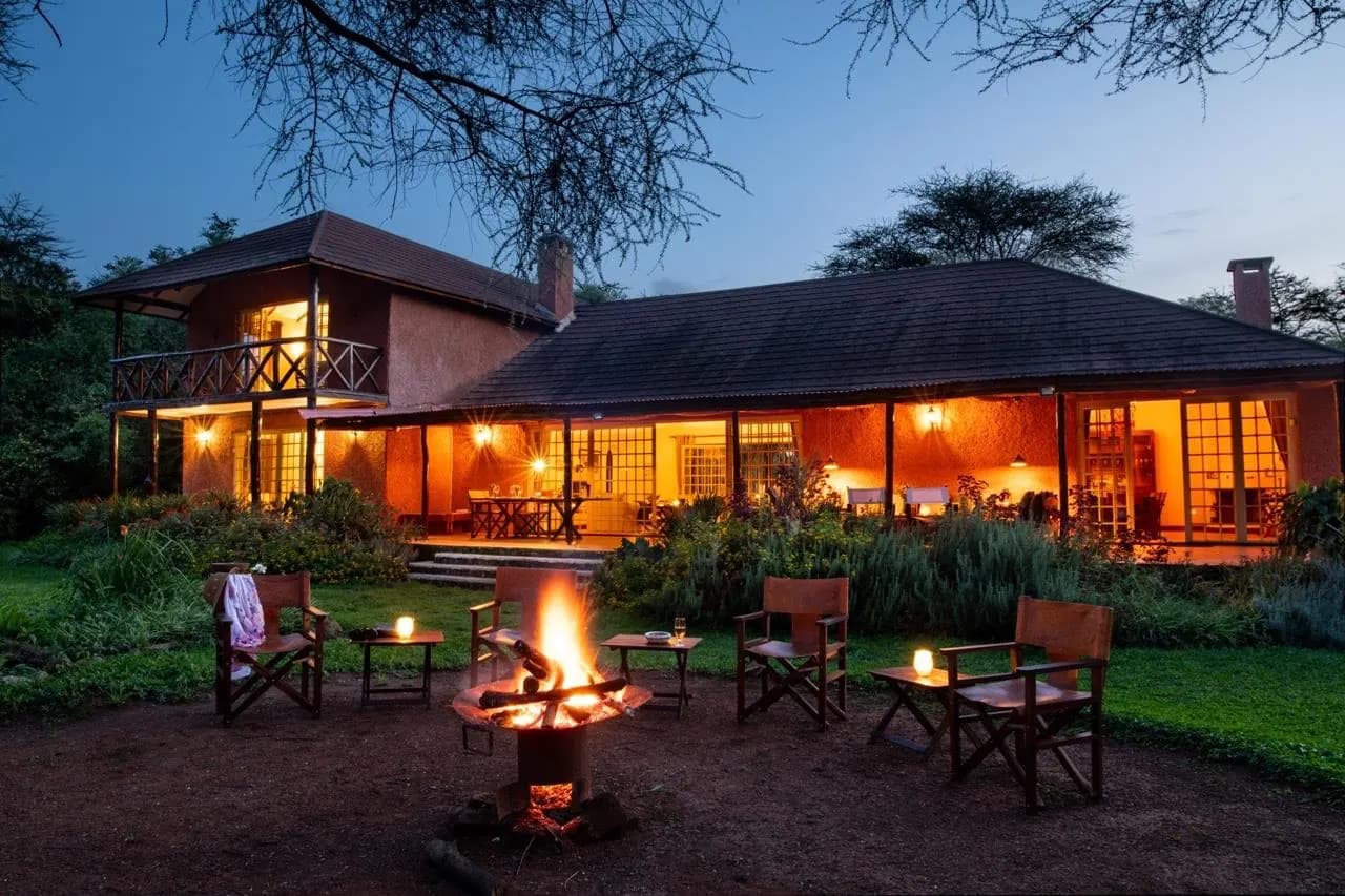The villa at dusk with the fire lit