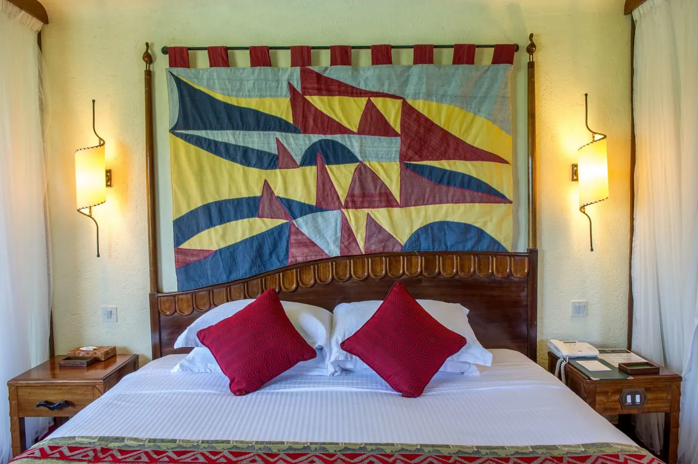 Bed beneath a painted hanging