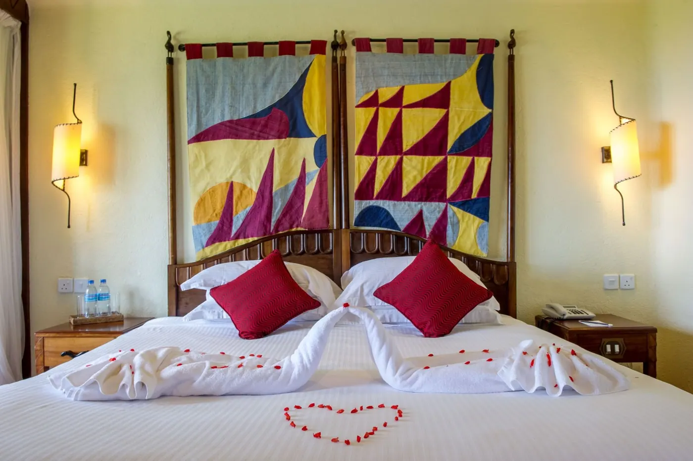 Twin beds turned down with petals