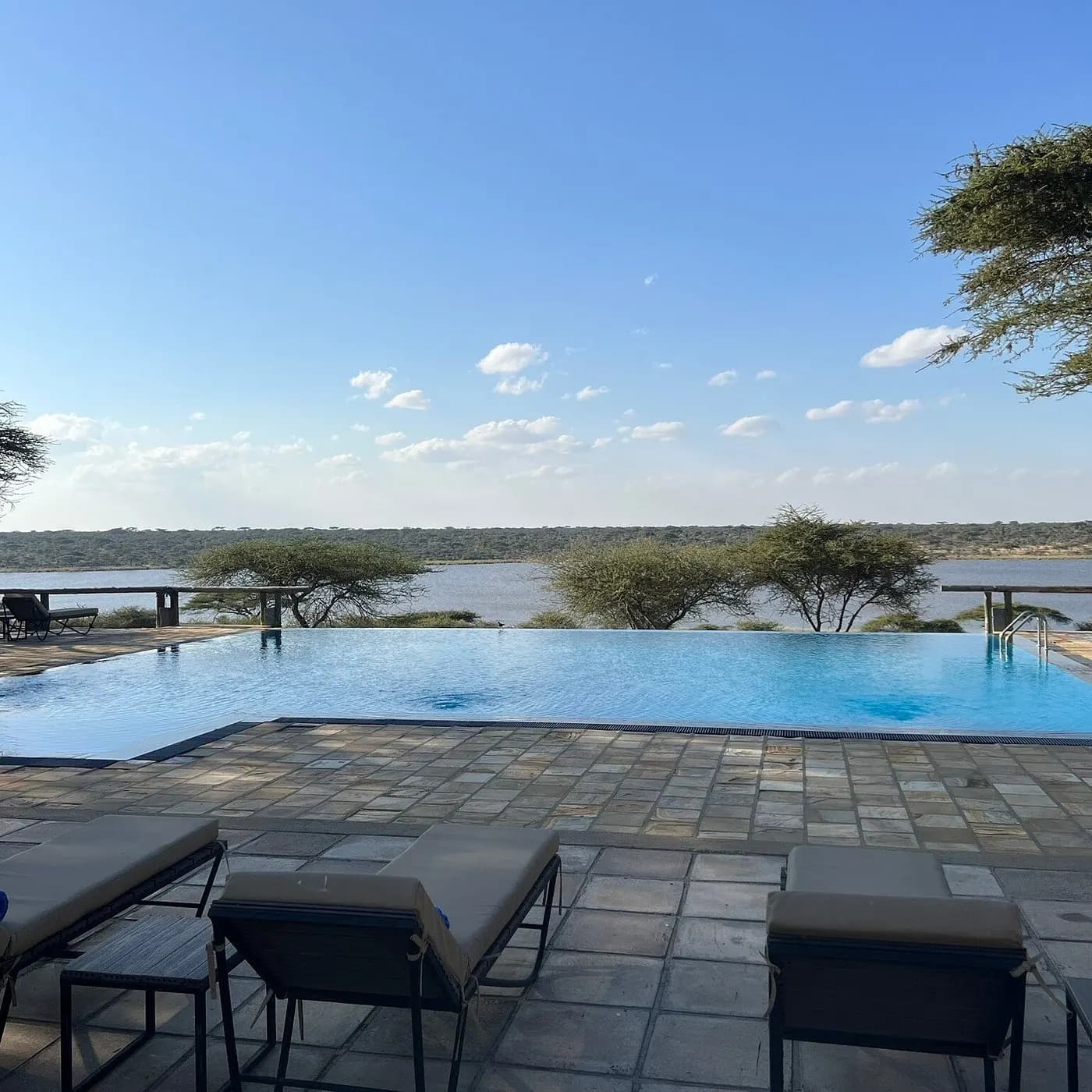 Pool and loungers by the lake