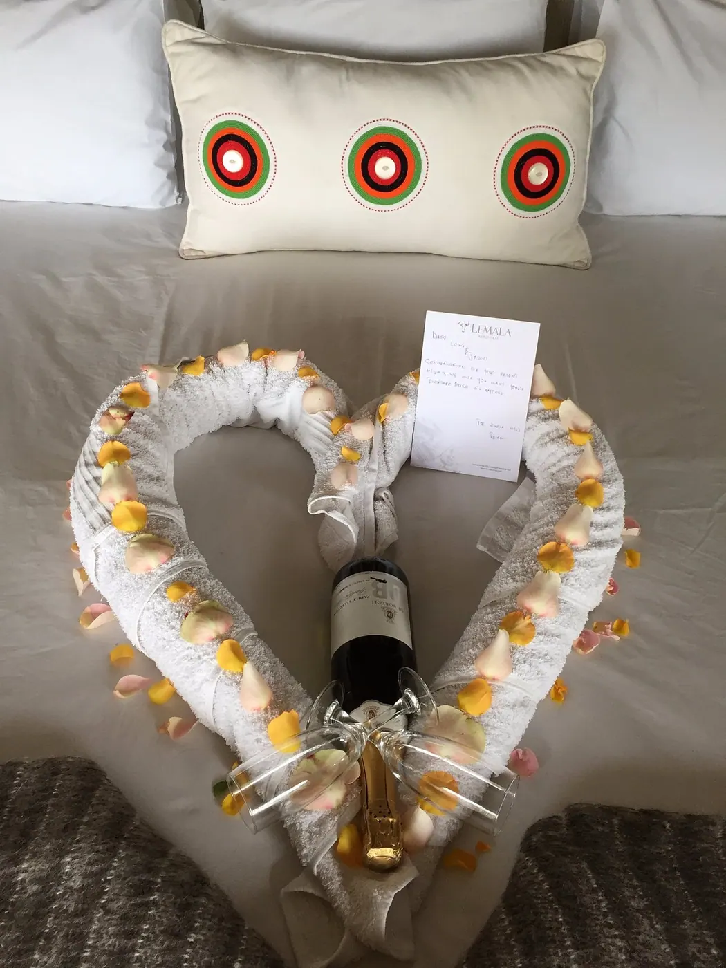 Turndown with a petal heart on the bed