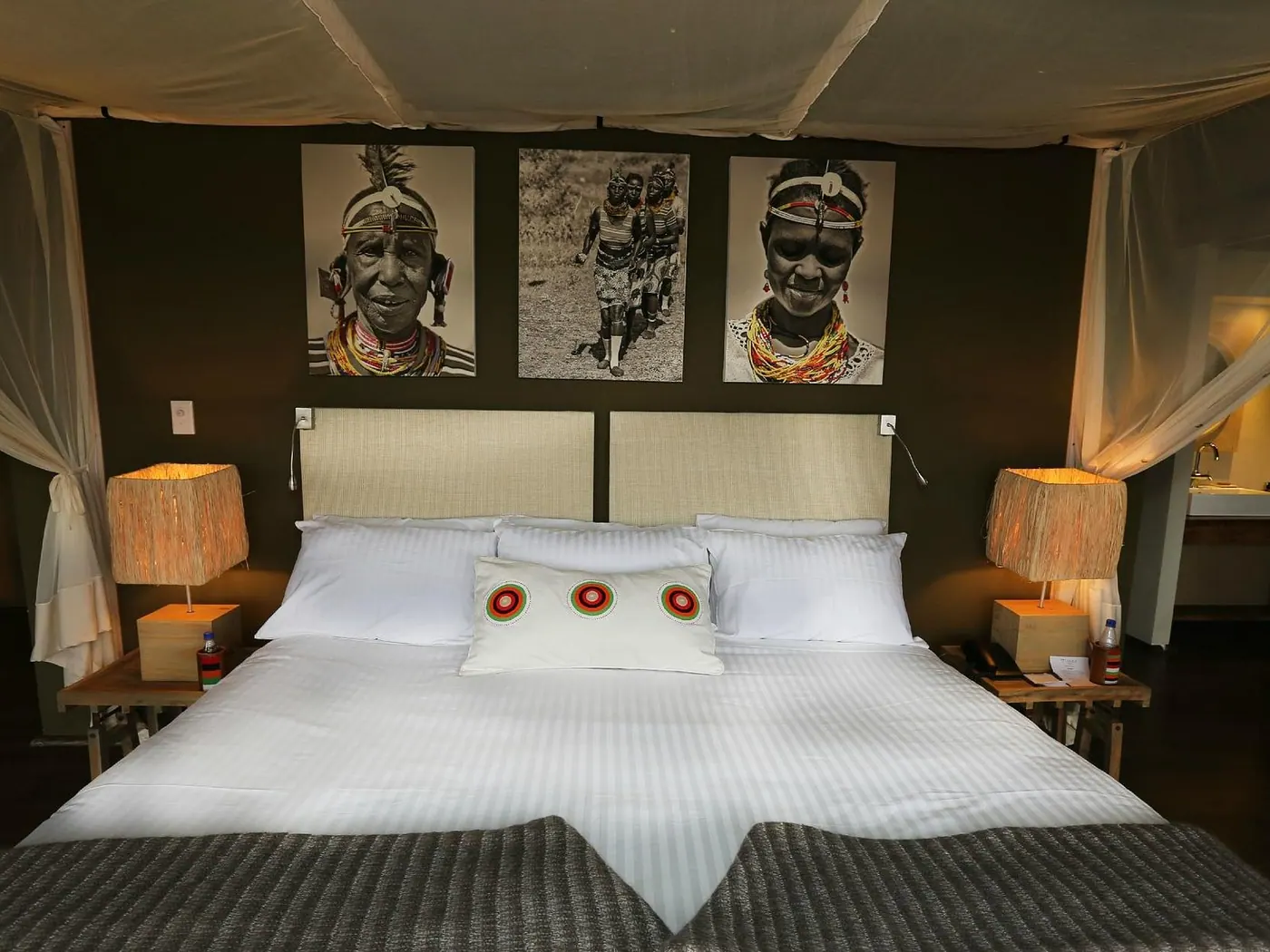Twin beds beneath portrait prints