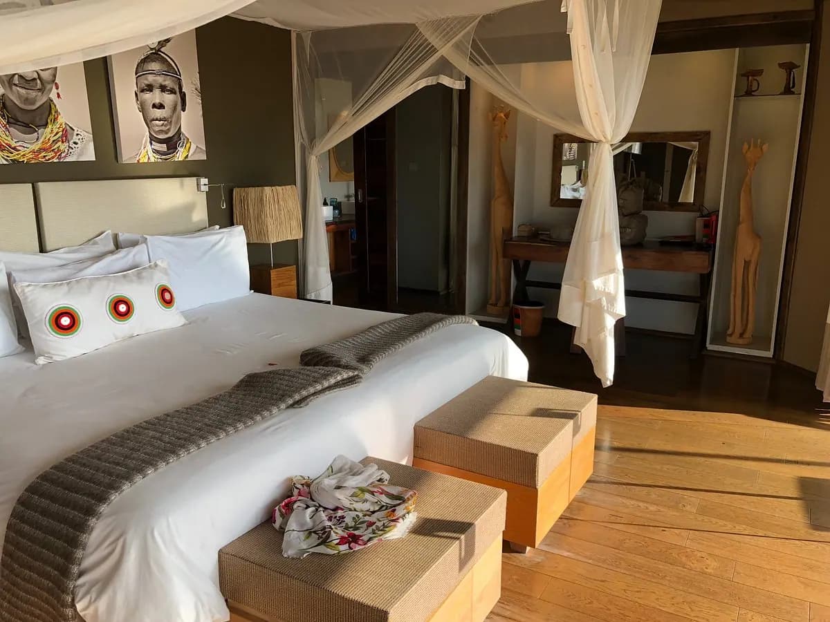 Bed with carved mask above