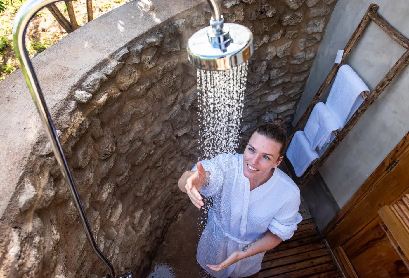 Outdoor shower set into the stone wall