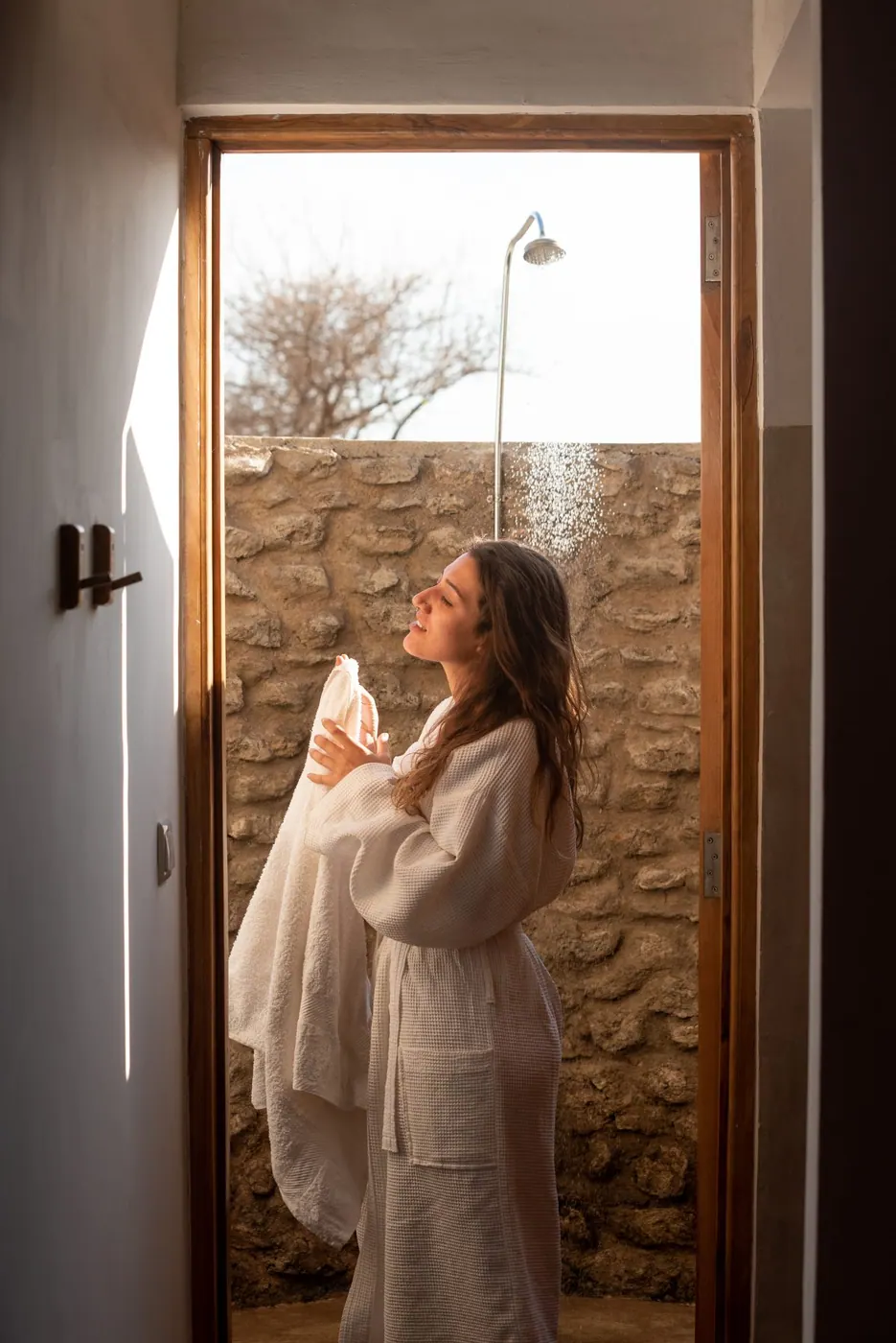 Guest in a robe at the suite door