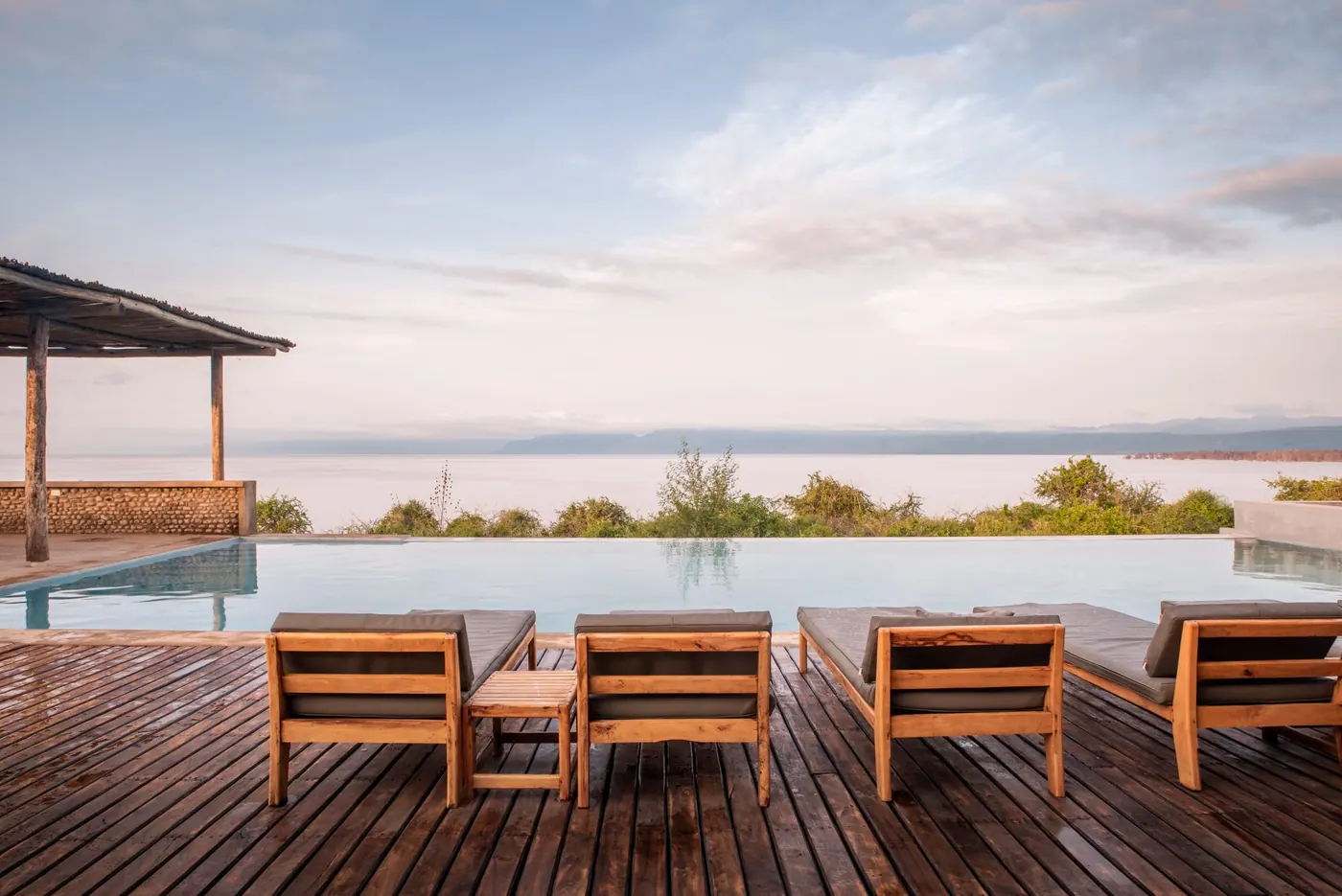 Deck chairs facing the lake at dusk