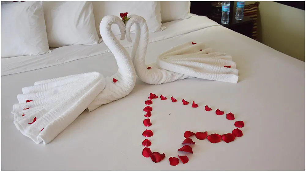 Turndown with petals and swans