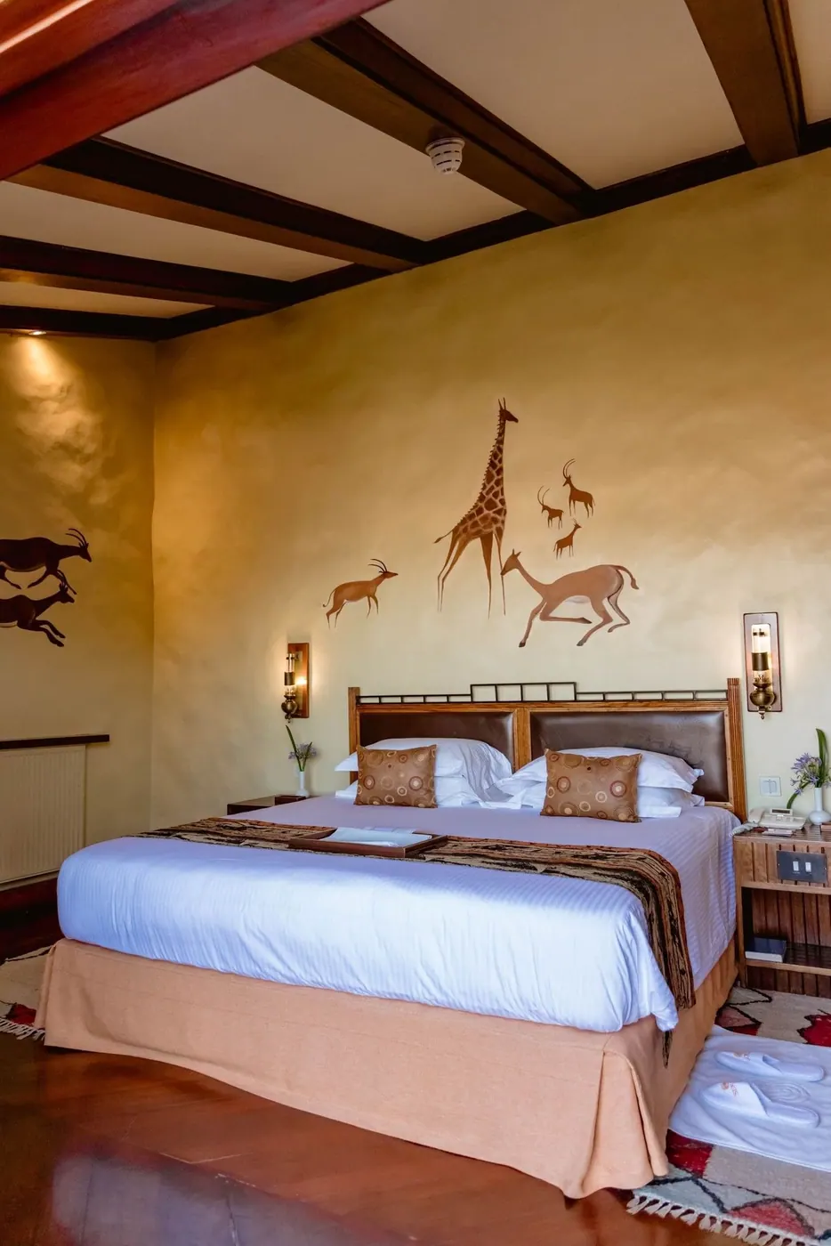 Bed beneath the painted frieze