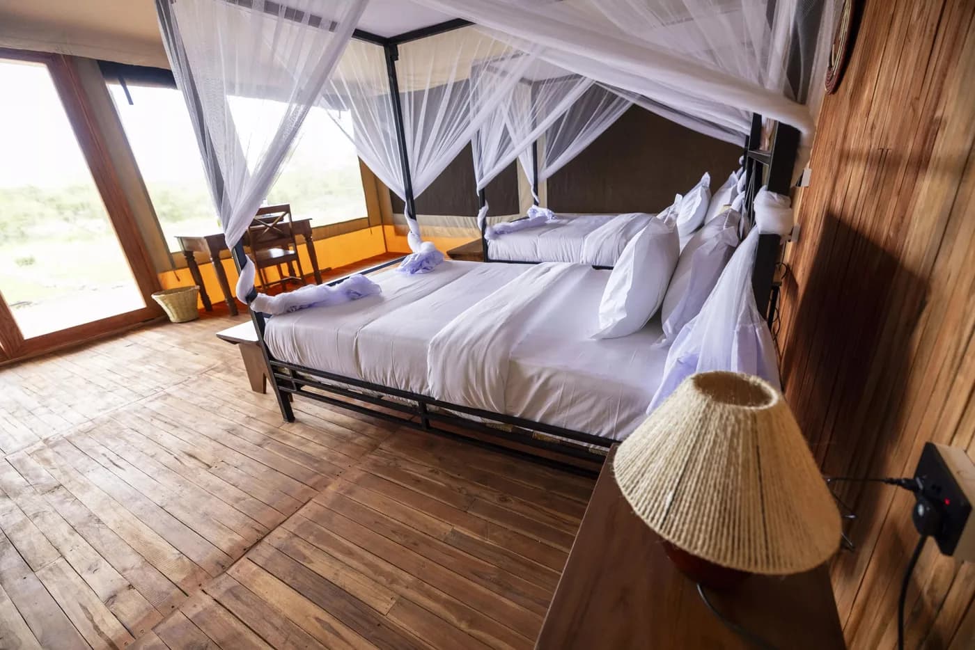 Canopied double bed on the wooden floor