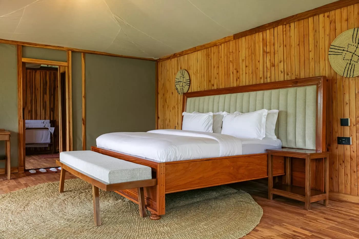 King bed in a timber-lined tent