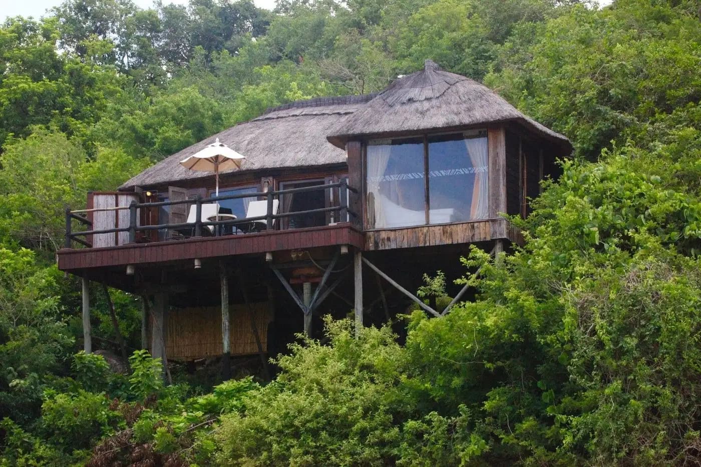 Thatched chalet raised in the forest