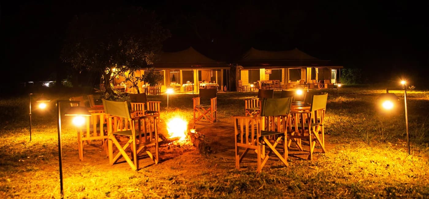 Campfire and chairs after dark