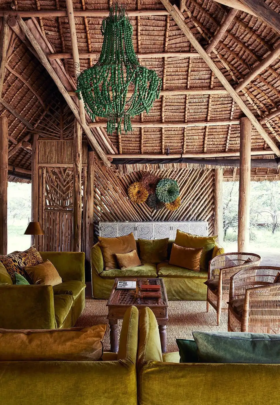 Sofa beneath a beaded wall hanging