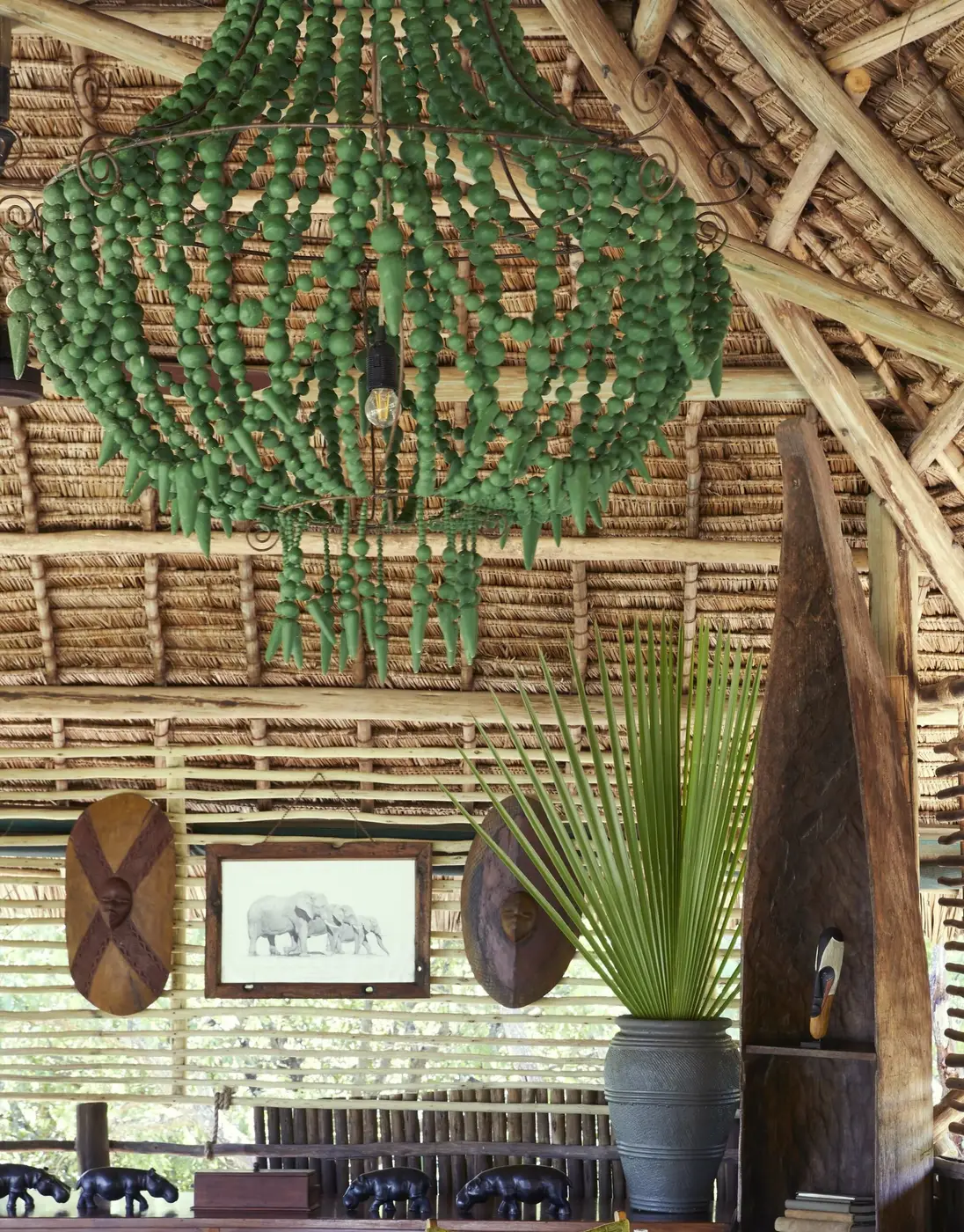 Green clay-bead chandelier under the thatch