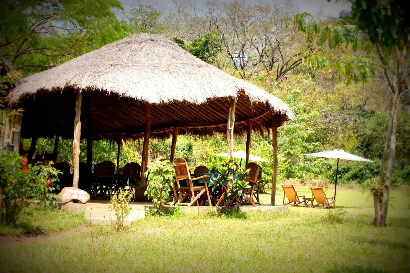 Thatched dining area in the gardens