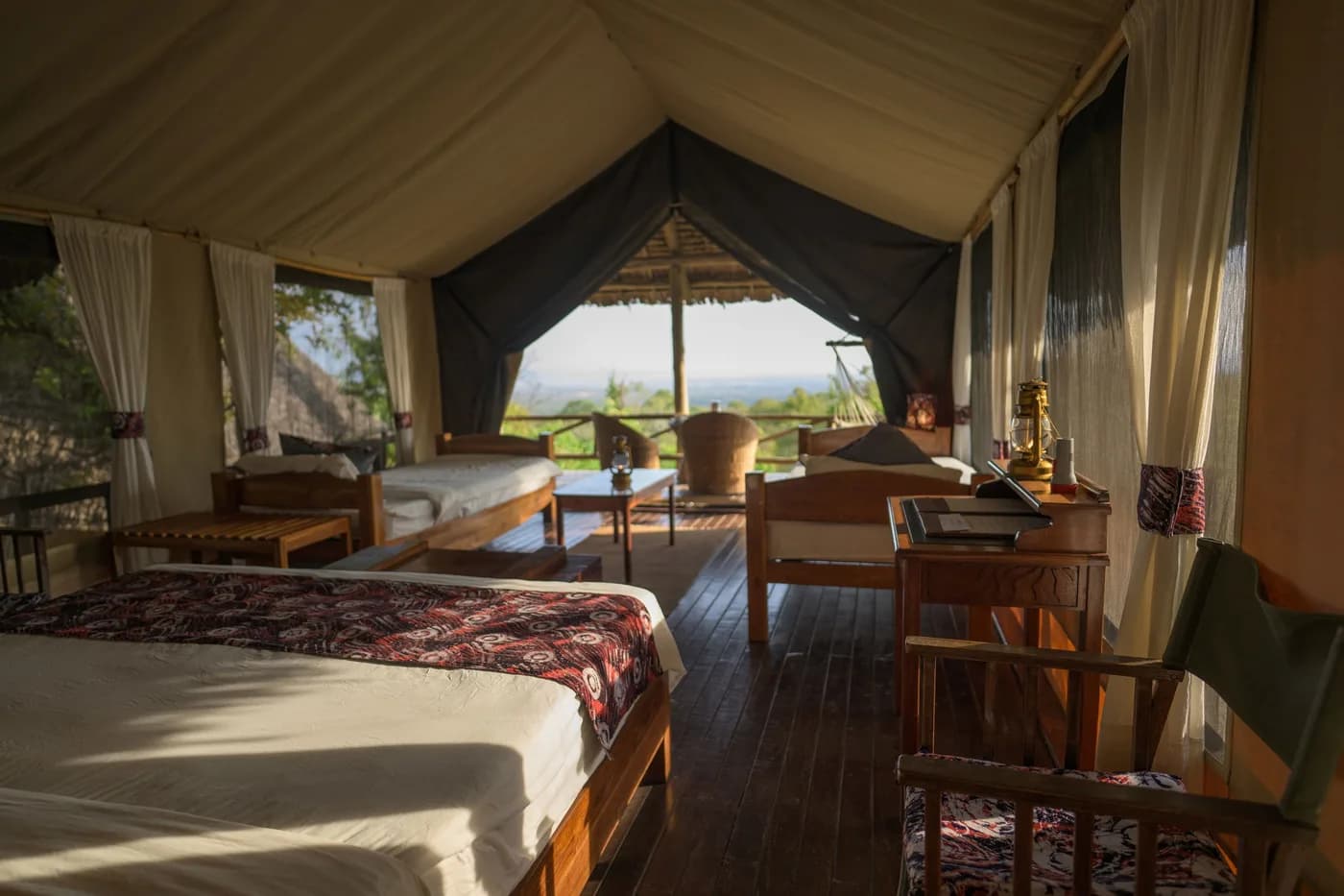 Tent interior with twin beds and a veranda