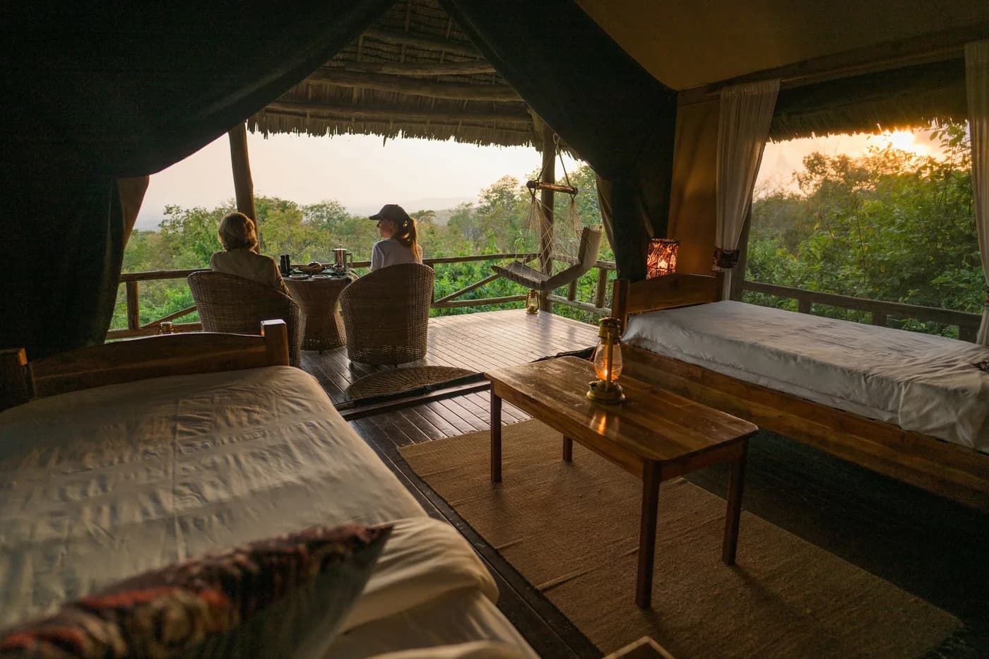Guests on a tent veranda at dusk