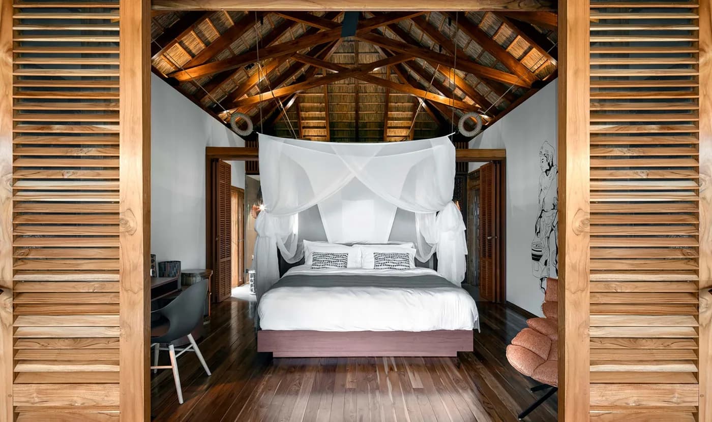 A bungalow bedroom under a timber roof