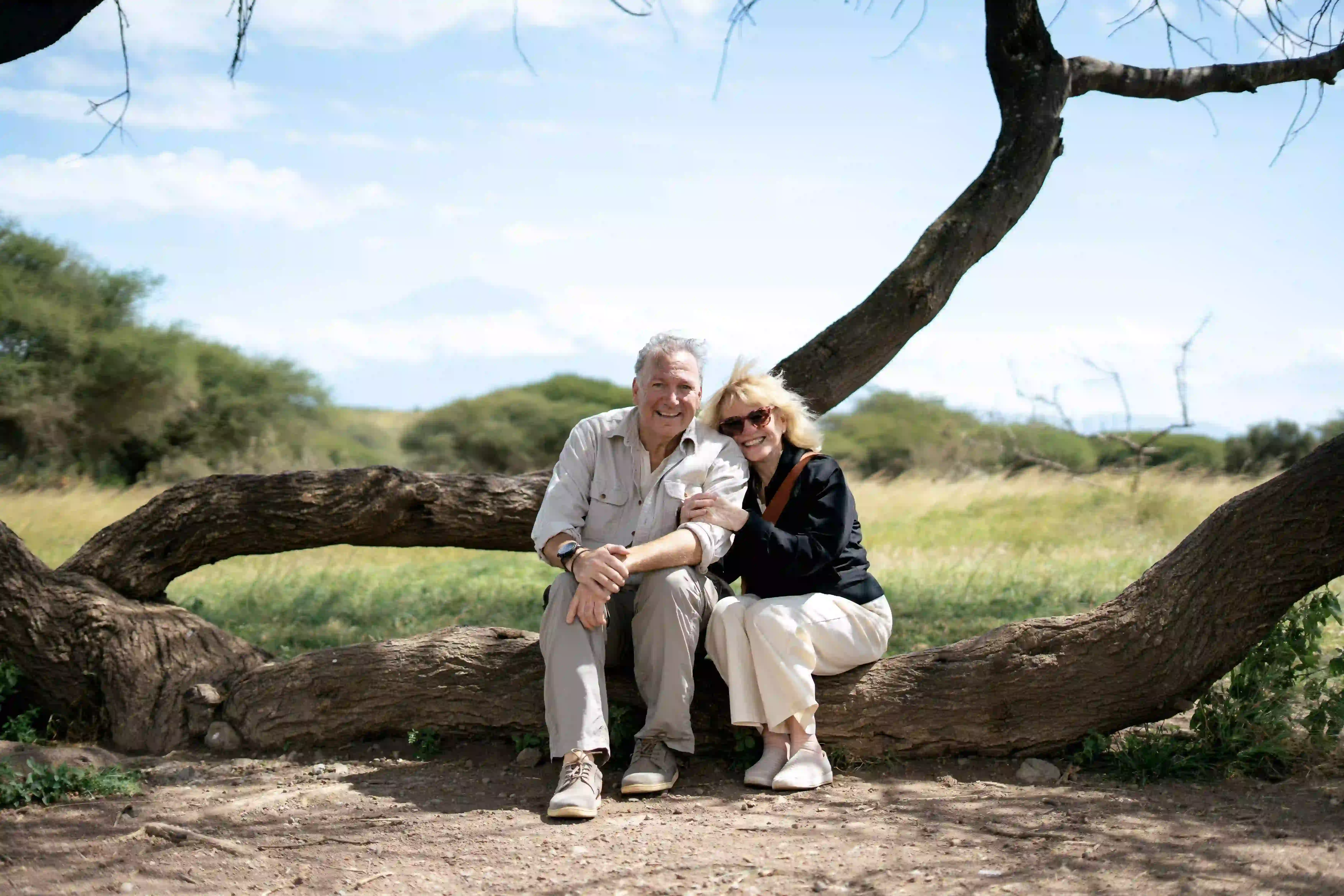 Couple sitting together on a fallen tree