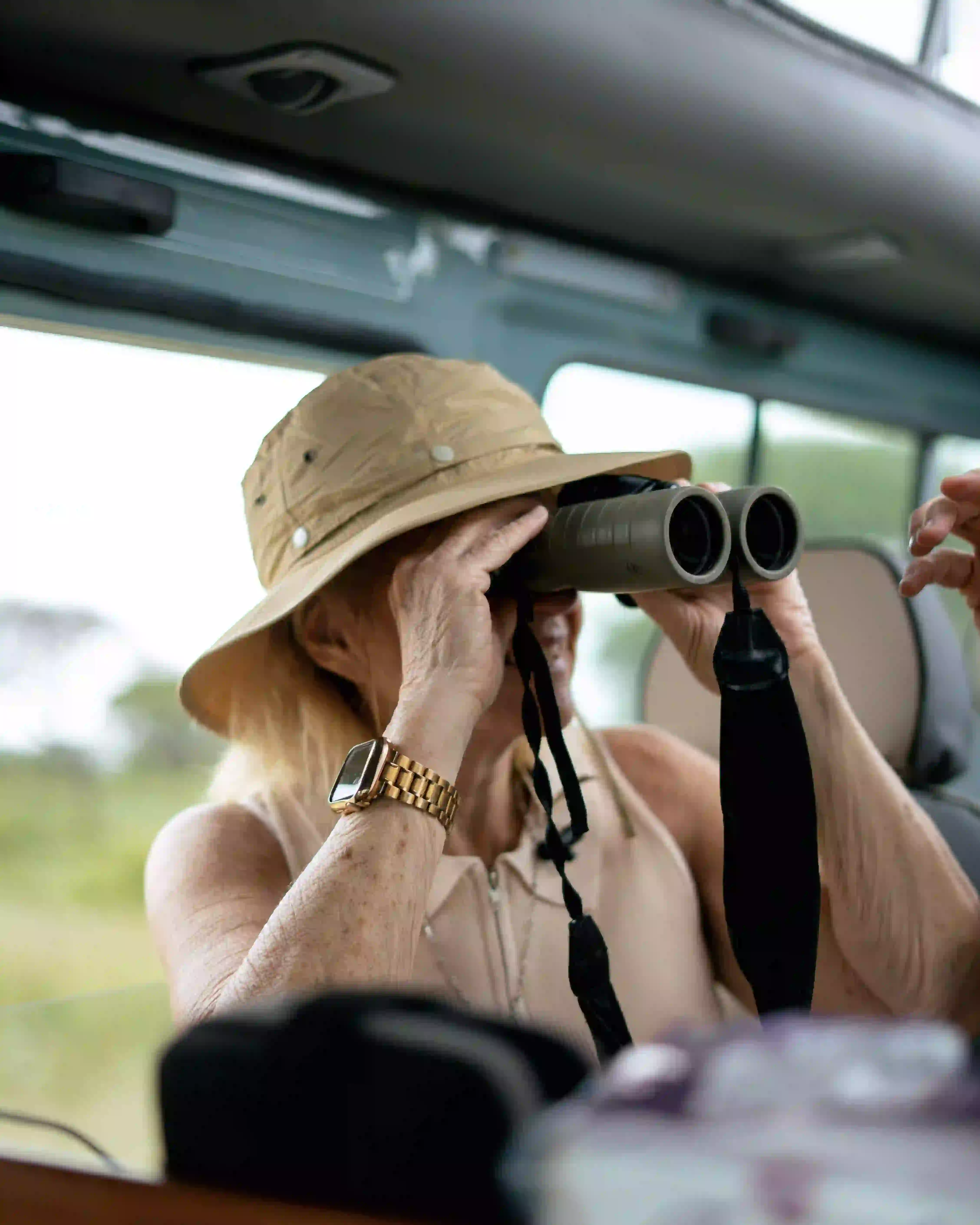 Woman scanning horizon with binoculars