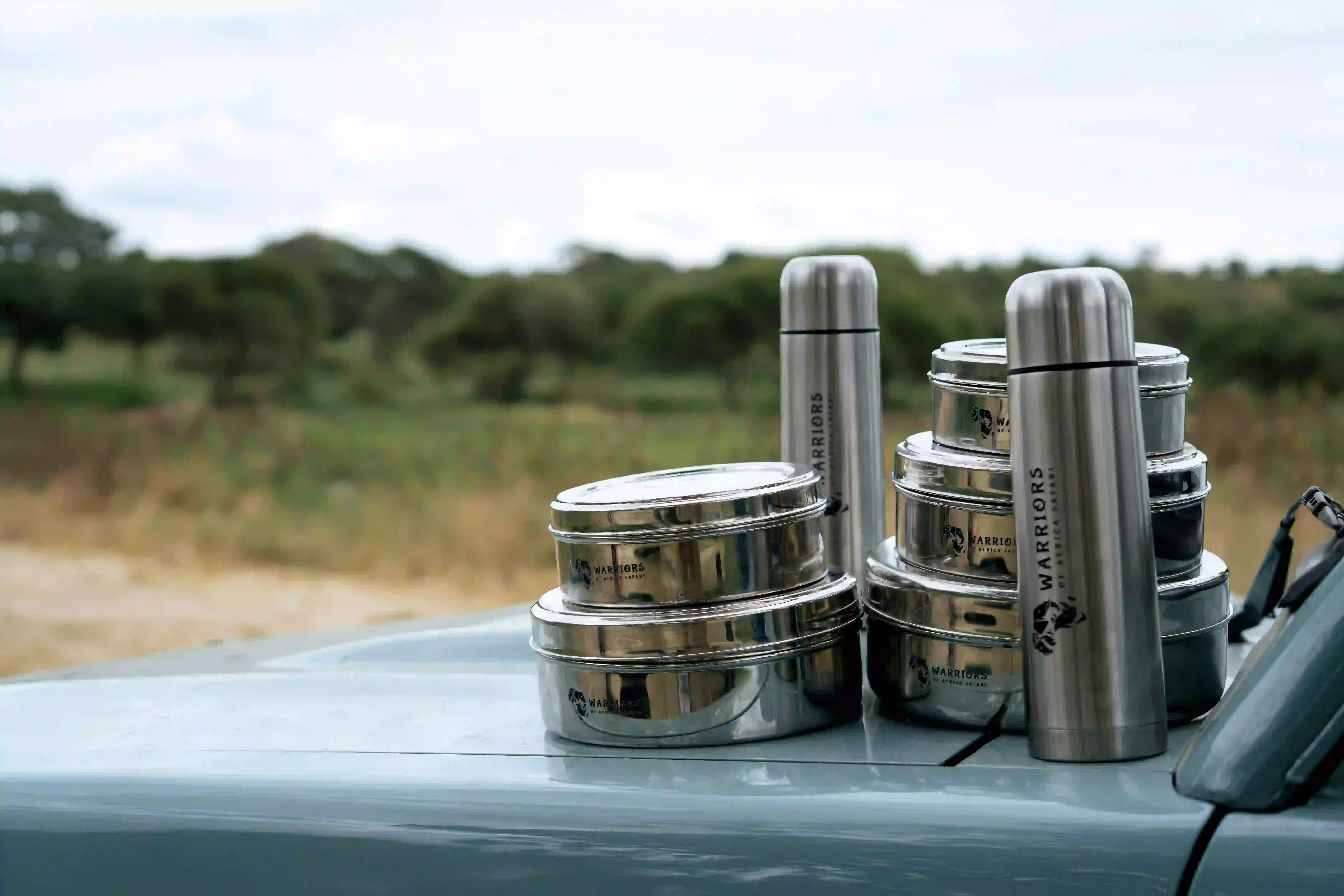 Branded picnic containers and thermoses on car hood