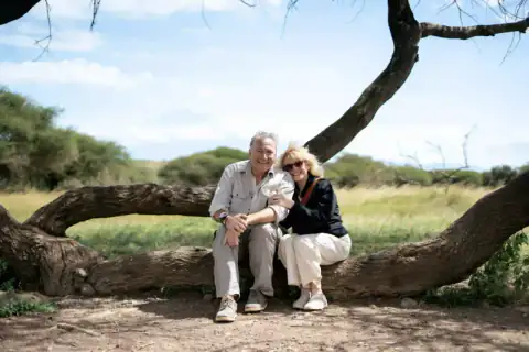 Couple sitting together on a fallen tree