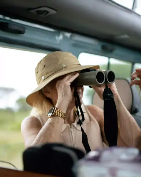 Woman scanning horizon with binoculars