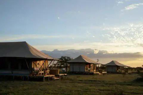 Row of luxury tents and deck at sunset
