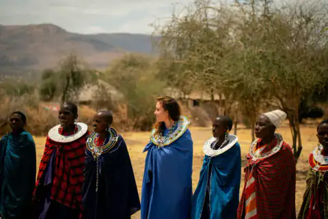 Guest among Maasai women in beaded collars