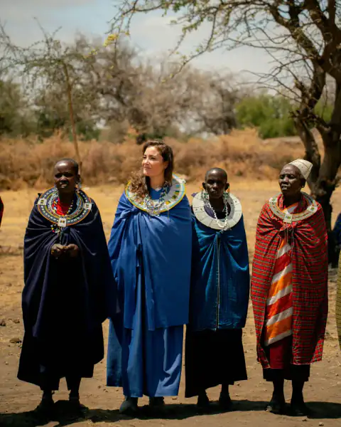 Portrait of a guest between Maasai elders in beaded collars