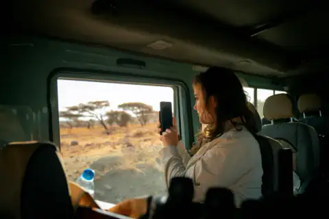 Guest photographing the plains from the vehicle
