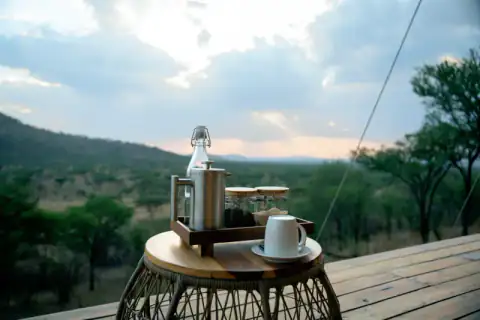 Coffee tray waiting on the tented-camp deck at dawn