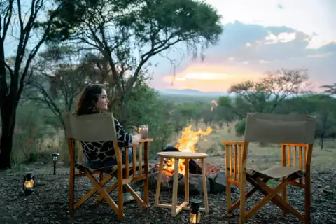 Fire pit and director's chairs at camp sunset