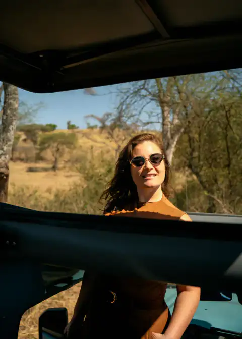 Guest smiling through the vehicle roof hatch