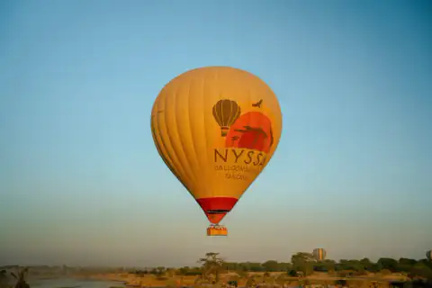 Balloon drifting over the Serengeti at sunrise