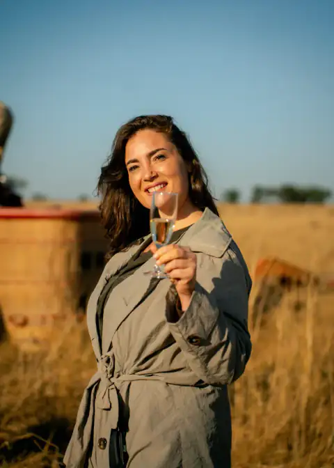 Guest raising a glass after her balloon flight