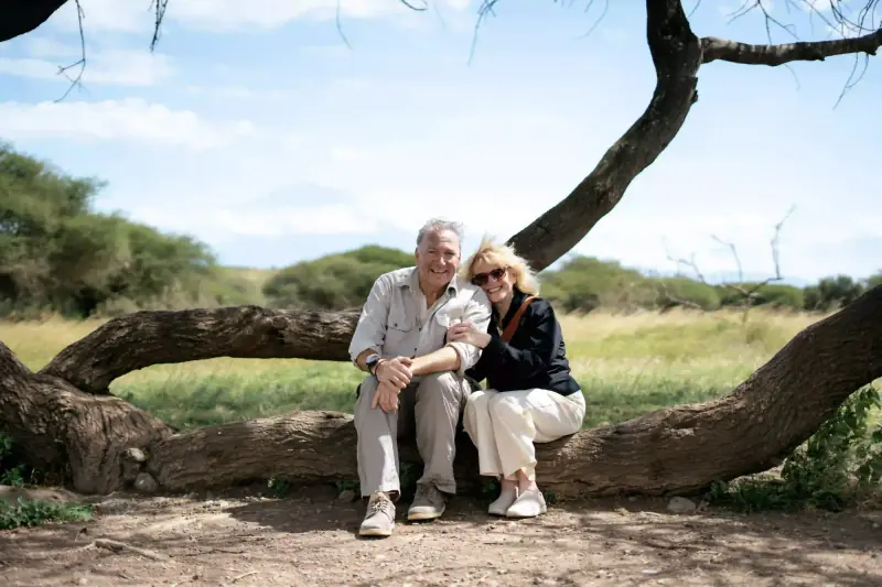 Couple sitting together on a fallen tree