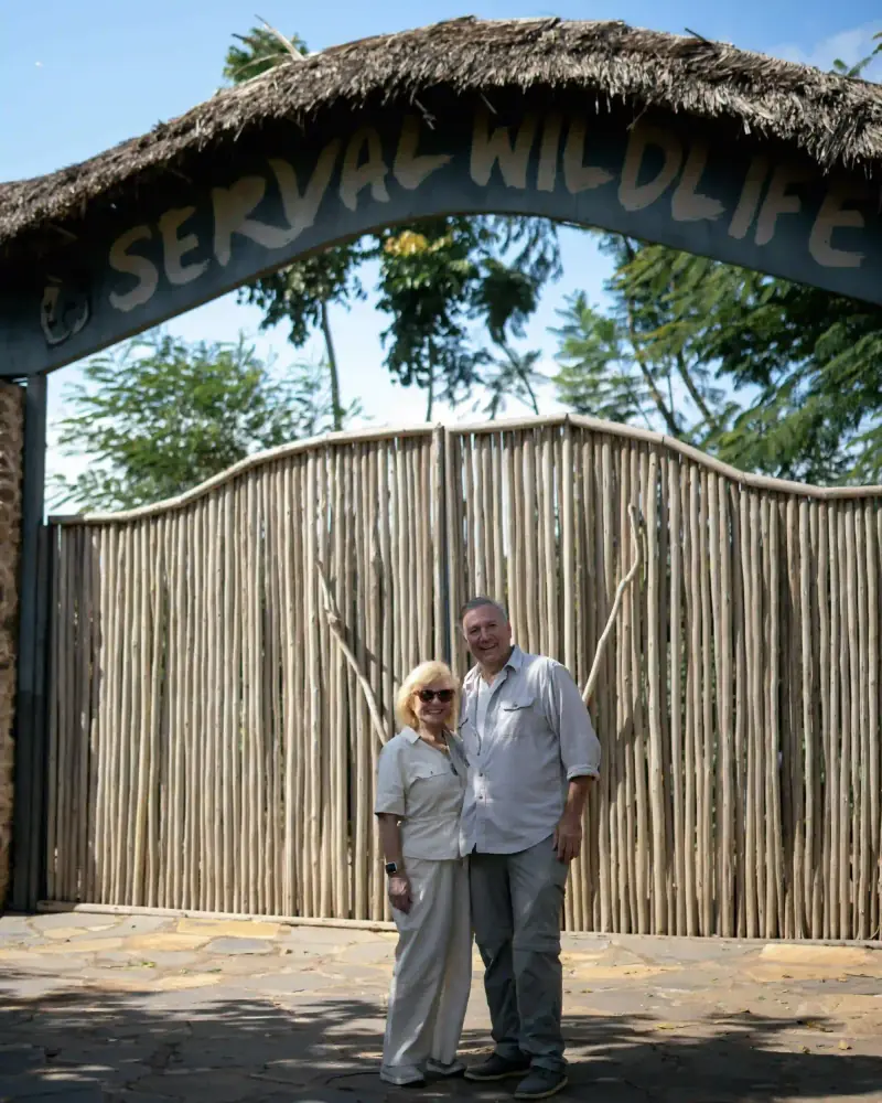 Couple at Serval Wildlife Sanctuary entrance sign
