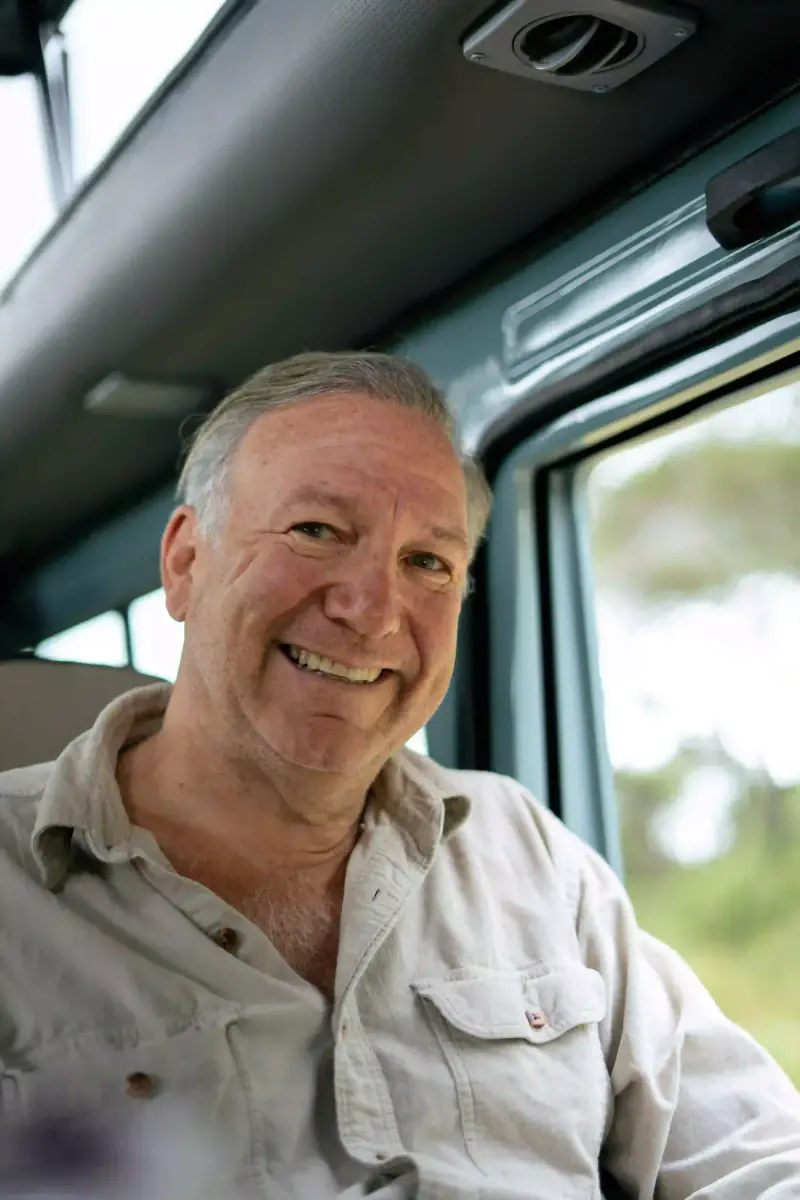 Man smiling inside safari vehicle