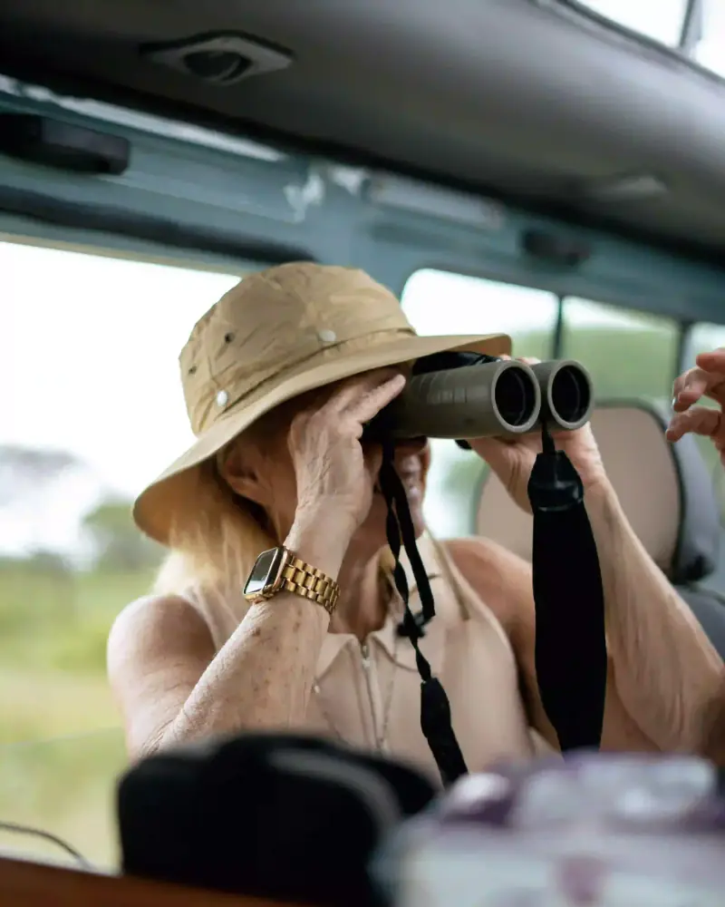 Woman scanning horizon with binoculars