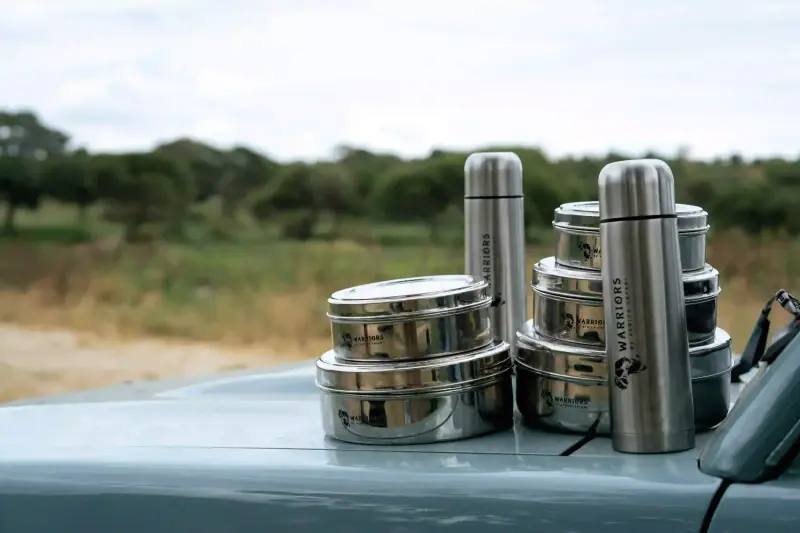 Branded picnic containers and thermoses on car hood