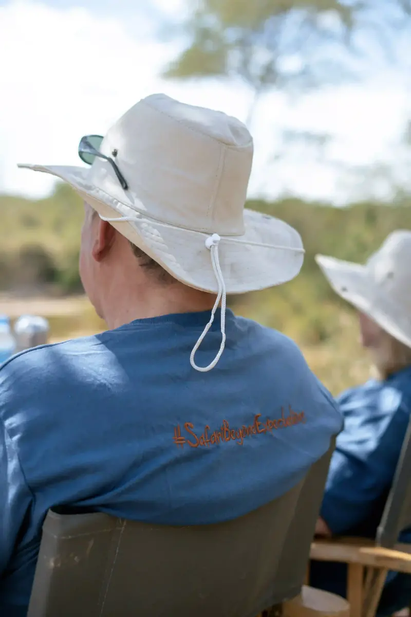 Man in safari hat with branded shirt