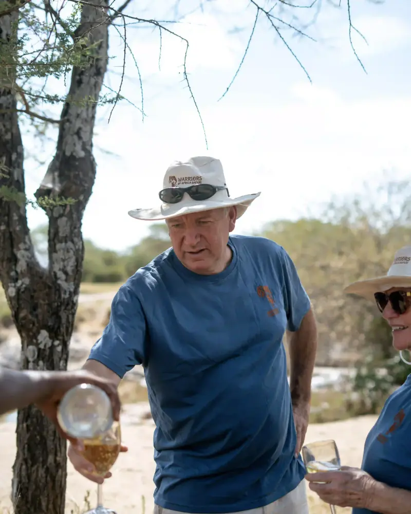 Man pouring a drink for companion